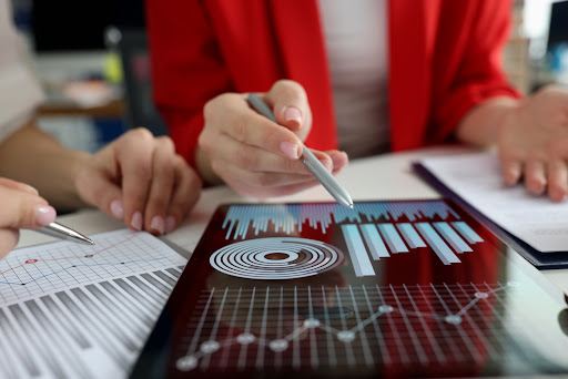 Businesswoman reviews charts to identify operational challenges