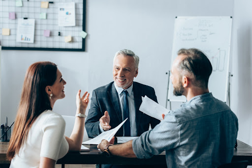 A manager greets a group of interim talent.