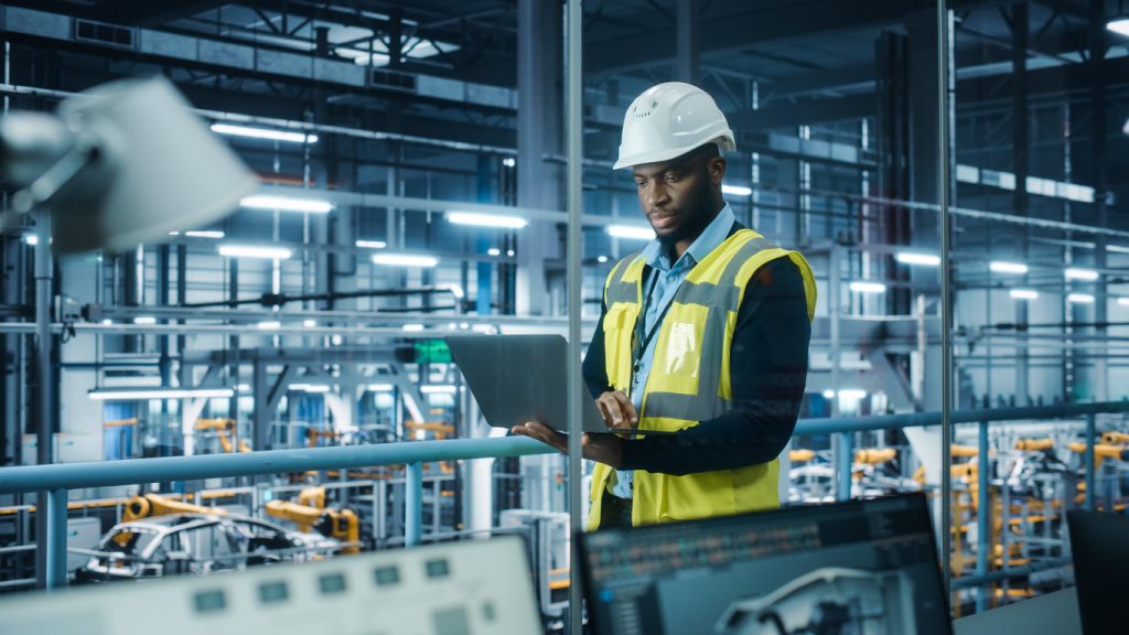 A manufacturing employee uses technology as part of an overall digital transformation